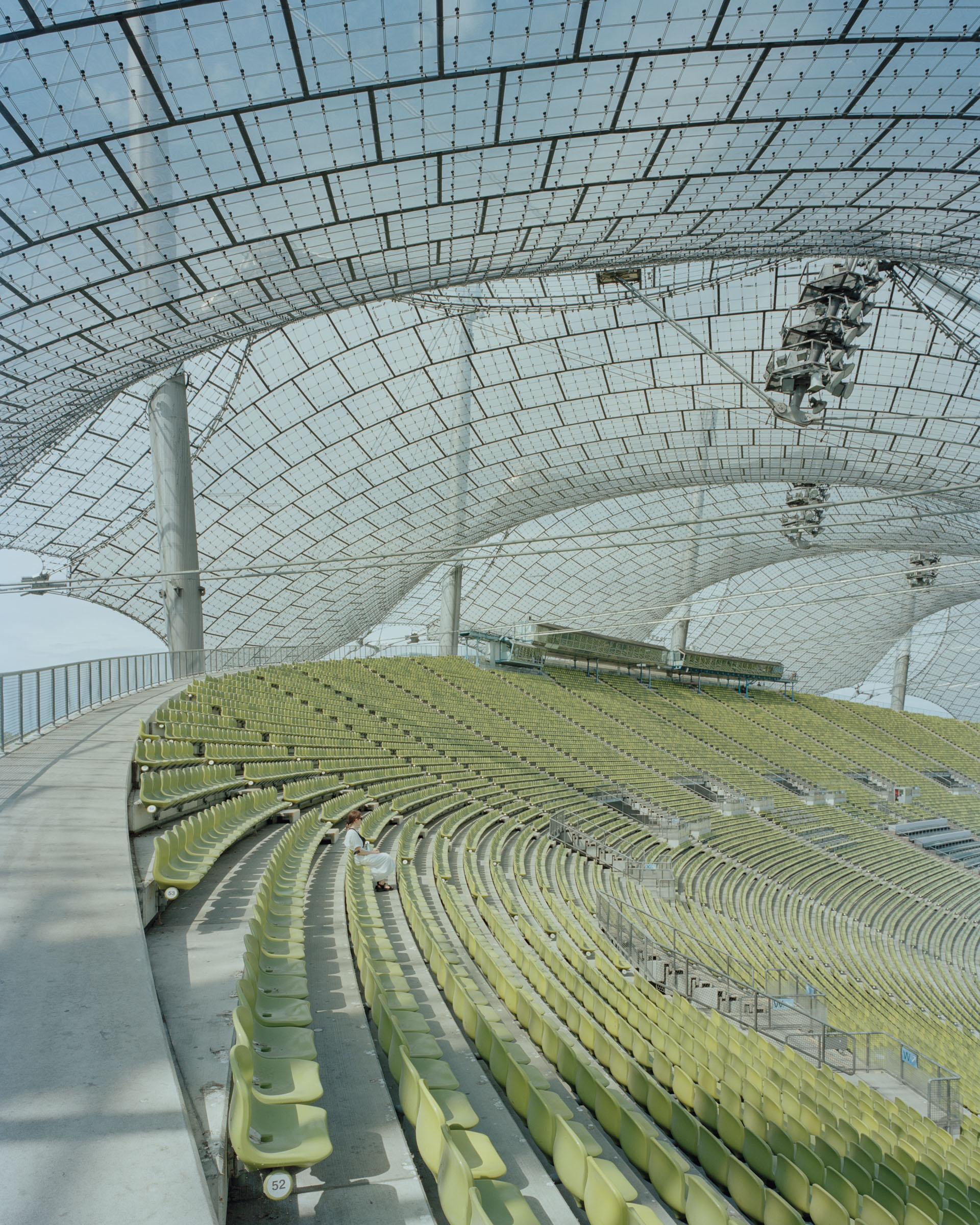 Analog architectural photography and documentation of the Olympiastadion in Munich, Germany—a unified structural space featuring the pioneering tensile roof—designed by Günter Behnisch and Frei Otto. Photographed by Piotr Hraptovich, architectural photographer based in Basel, Switzerland. Analoge Architekturfotografie und Dokumentation des Olympiastadions in München, Deutschland—eines einheitlichen Raums mit wegweisender Zelt-Dachkonstruktion—entworfen von Günter Behnisch und Frei Otto. Fotografiert von Piotr Hraptovich, Architekturfotograf mit Sitz in Basel, Schweiz. 